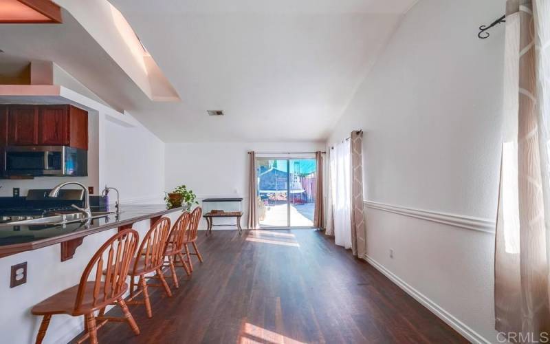 View from Dining Room toward kids work/play area and sliding doors leading to the backyard