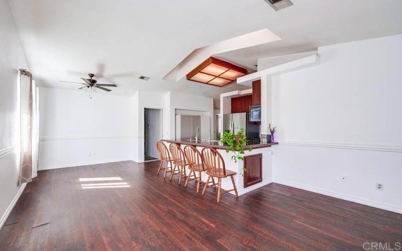 Open Concept Floor Plan; view from den/kids area to Kitchen & Dining Room;  lots of natural light