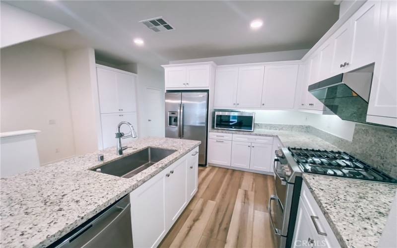 The kitchen is on the second level and features stainless steel appliances and an island.