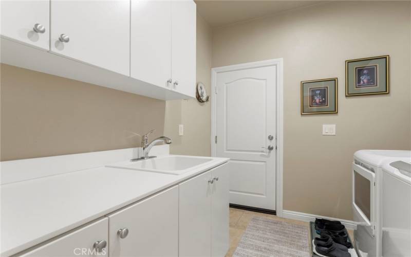 Laundry room with cabinet space and sink