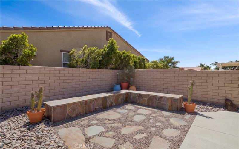 Custom stone seating area in backyard