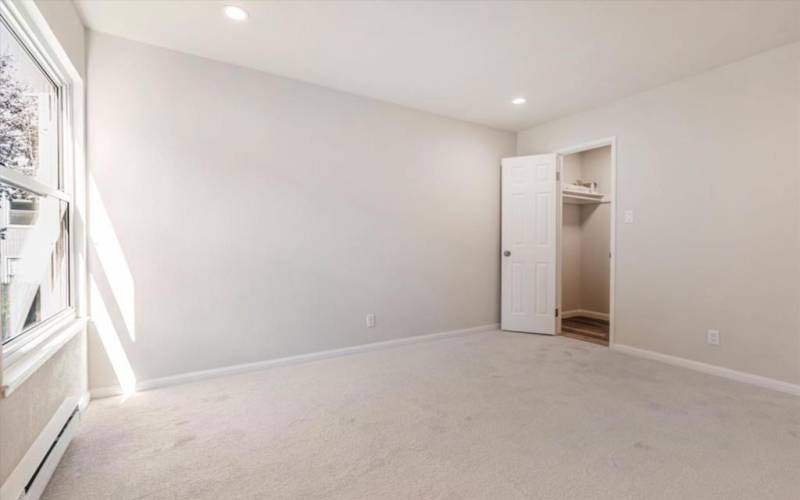 Primary bedroom with walk in closet and vacant