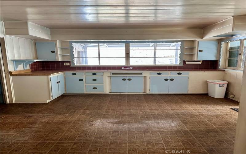 Kitchen from living room, walking in pantry on left, exit through Dutch door to screen patio.