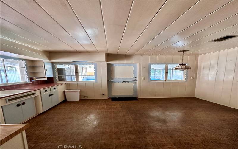 Kitchen view from pantry, out the dutch door is screen patio