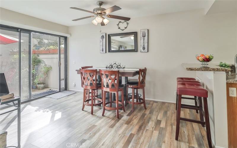 Beautiful dining area looking out onto patio and into kitchen and living room