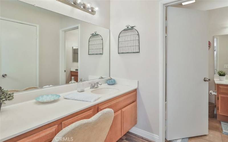 Private sink attached to primary bedroom leading into bathroom