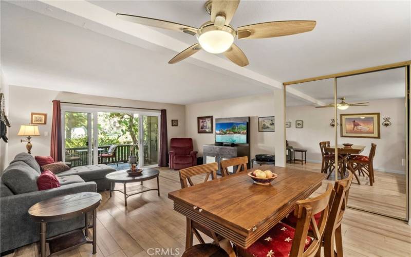 Dining area and living room looking out to the patio and nature.