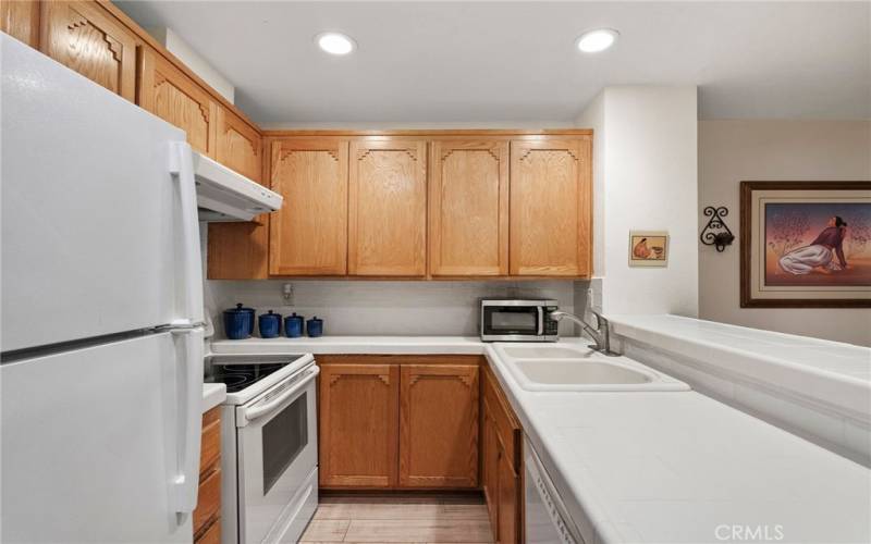 Freshly painted kitchen with new tile backsplash and a large breakfast bar.