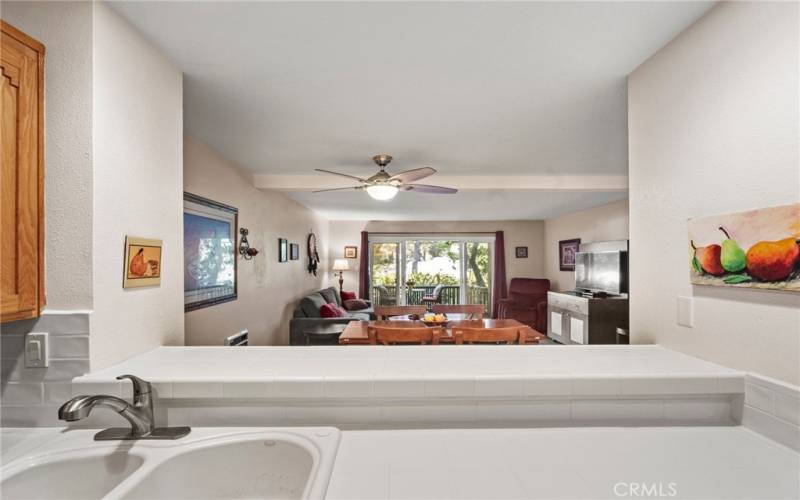 A view out from the kitchen to the dining area and living room. 
