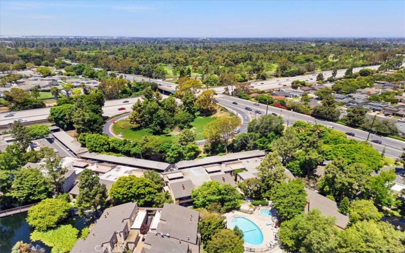 Aerial view of the main pool and clubhouse with the freeway in the distance.