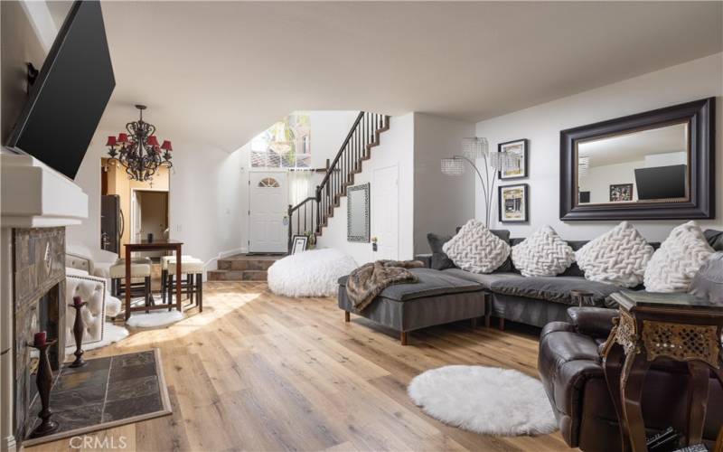 Living and dining area looking toward entry and staircase to 2nd level.