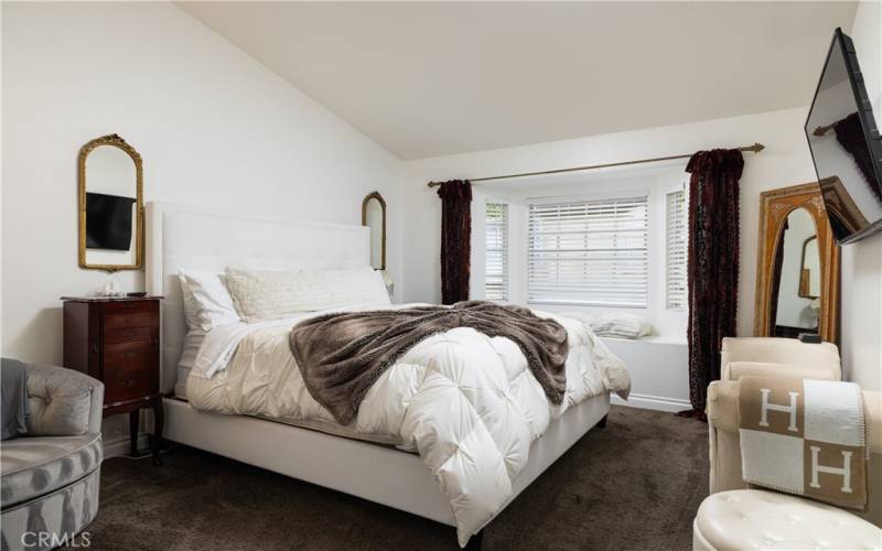 Vaulted ceiling and window seat in Primary Suite