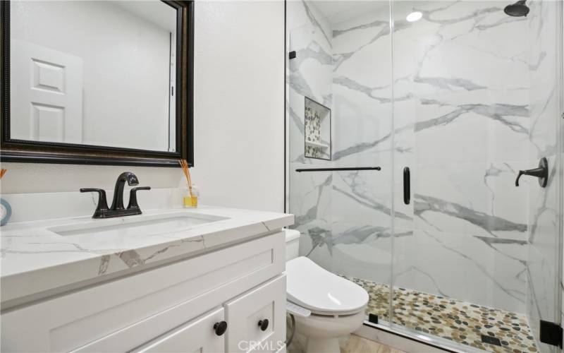 Additional attached bathroom has walk in shower