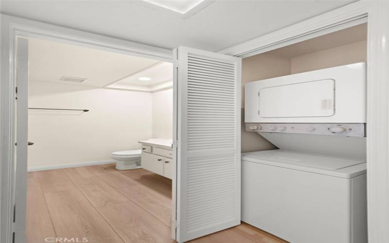 Laundry closet with stacked washer and dryer