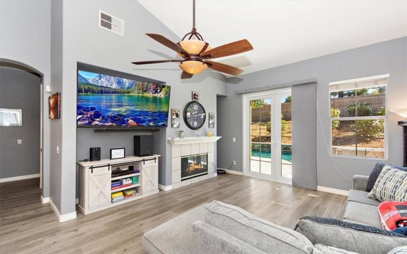 Family Room with inviting fireplace and French doors into the backyard