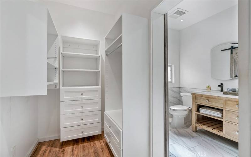 Combination of walk-in closet and master bathroom.