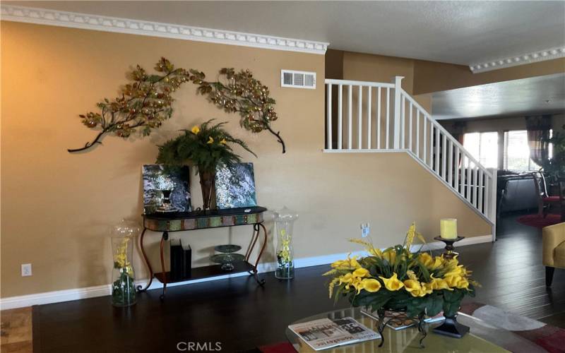 another view of the formal living and entry way to the kitchen  and staircase