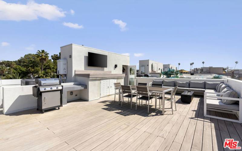 Private rooftop deck with outdoor tv, grill, fire pit, and furniture included upon request.