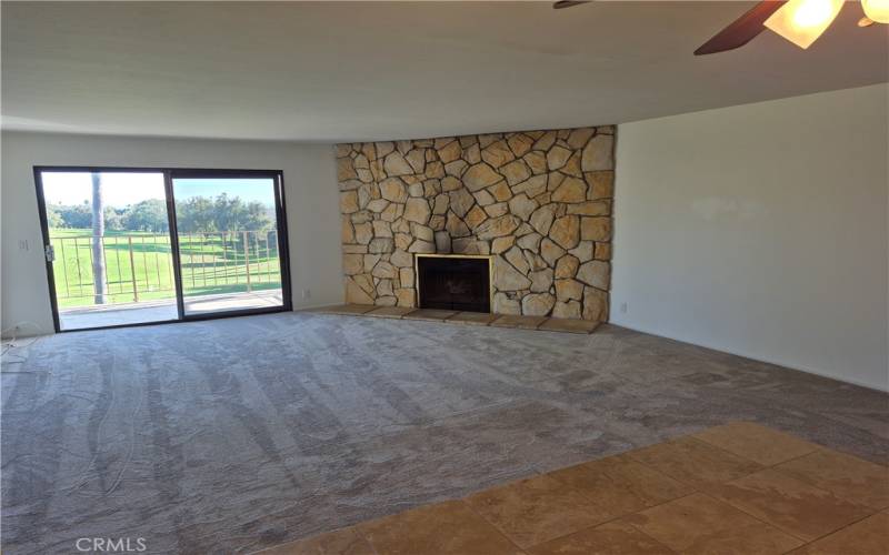 Living room with gas fireplace & slider to balcony