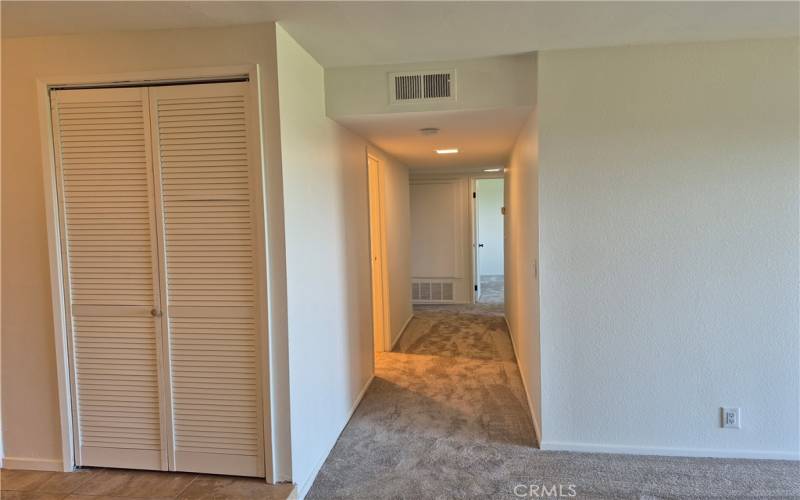 Hallway leading to bedrooms/baths. Laundry closet to the left.