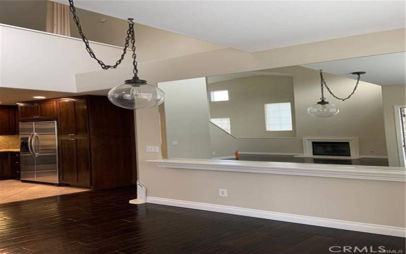 Here is a closer look at the dining room area with decoartive light fixture and mirrored wall