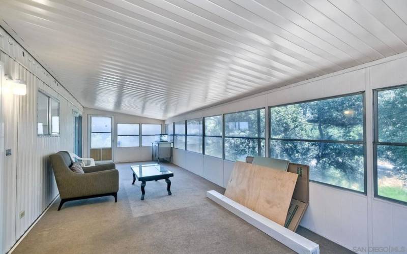 Enclosed California patio room overlooking the seasonal creek.