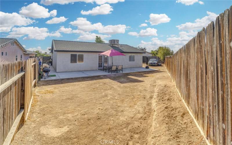 another view of rear yard! concrete on east side for easy walk to front yard.