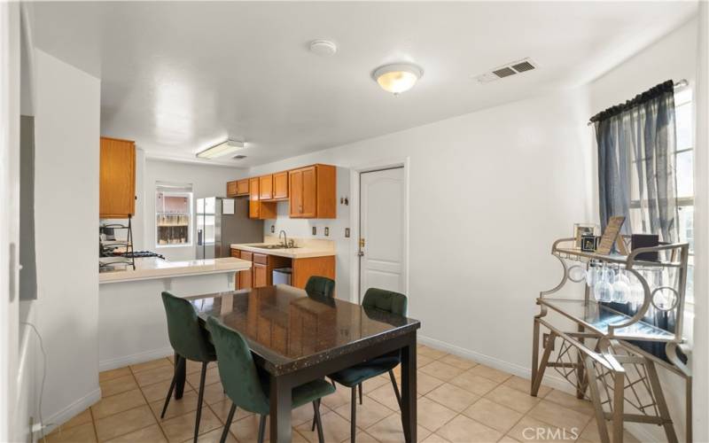 open and bright kitchen/dining area w/break fast bar. Window to check out who's approaching the door.