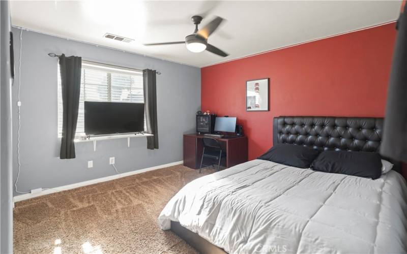 Guest bedroom w/street views, stand of motion lights at ceiling are included along with blinds, curtains and curtain rods.
