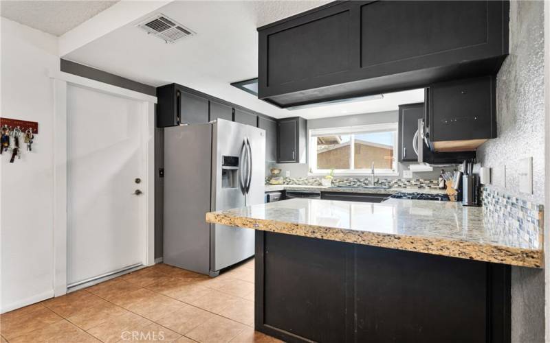 Kitchen has been upgraded with granite counters, and glass backsplash.