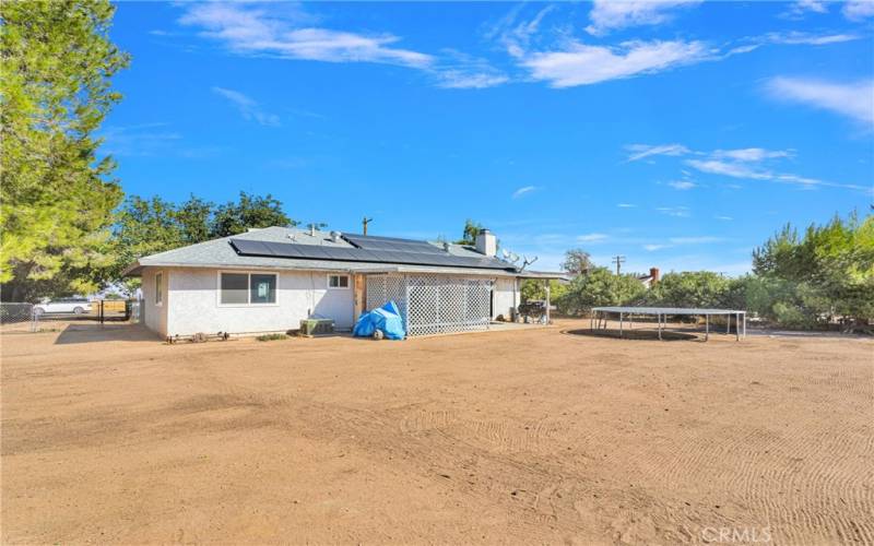 Large back yard with drive in access at side yard.