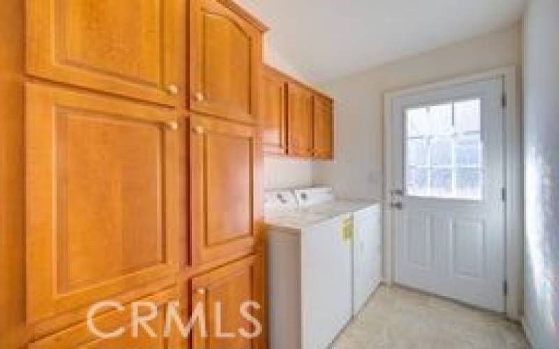 Laundry Room with a closet and lots of cabinets