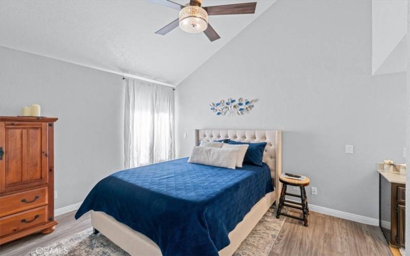 Primary Bedroom w/ensuite bathroom to the right. Vaulted ceilings and lots of light. Generous walk-in closet not shown.