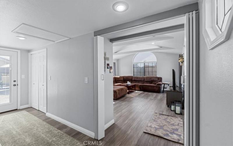 Entry to back living room with hallway to the left leading to the backyard and more storage down the hall.