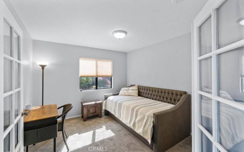 Bedroom Two with french doors and closet to the right behind the door