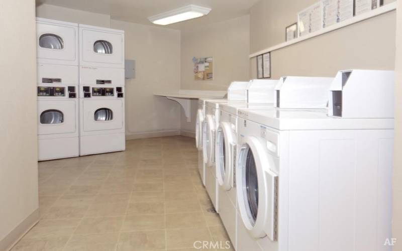 Community laundry located in garage by elevator 
