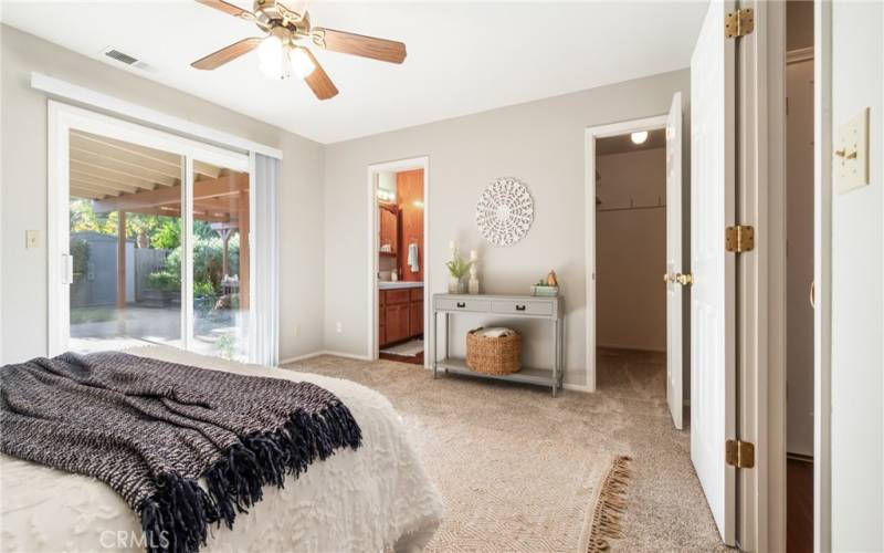 Primary bedroom with bathroom and walk-in closet