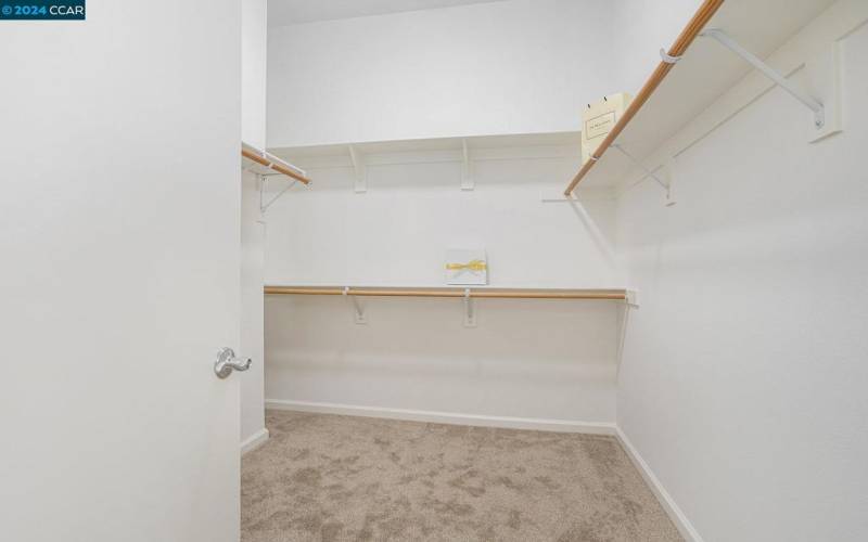 Huge walk in closet in primary bedroom -- room for all your clothes, bags & shoes