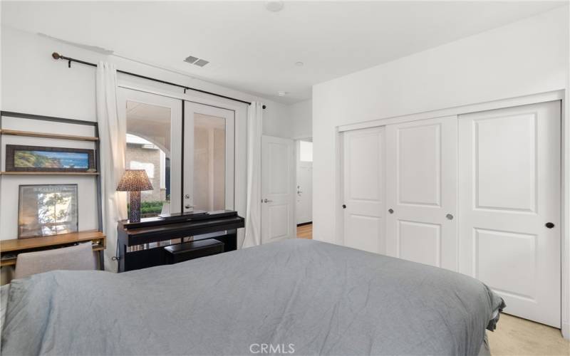 1st floor bedroom with french doors leading to the front patio