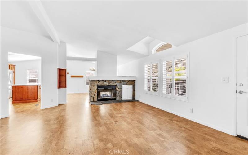 Giant windows grace the large living room with more plantation shutters, so classic.