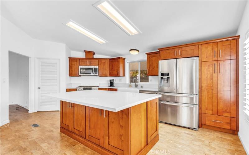 Additionally a WALK-IN PANTRY, comfortable and quiet cork flooring and many gorgeous quality dual pane windows, many with plantation shutters.