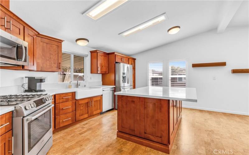 A fabulous kitchen with an open concept and high quality newer cabinetry, counters, island bar and quality stainless steel appliances. AND CHECK OUT THAT FARM SINK!!!