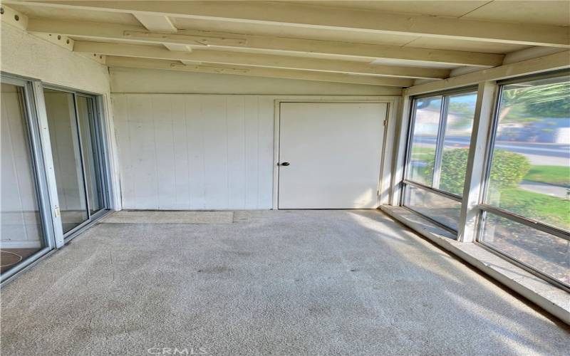 Photo of front enclosed patio with storage room