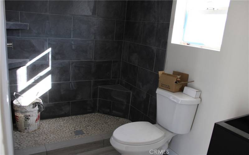 Walk-in tile shower in one of the primary baths