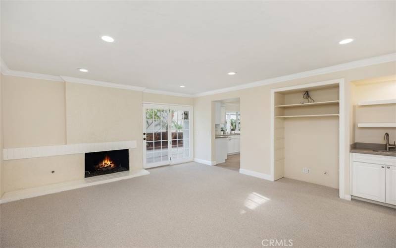 Den located off the living room includes another fireplace and bar area. Recessed lighting just added.