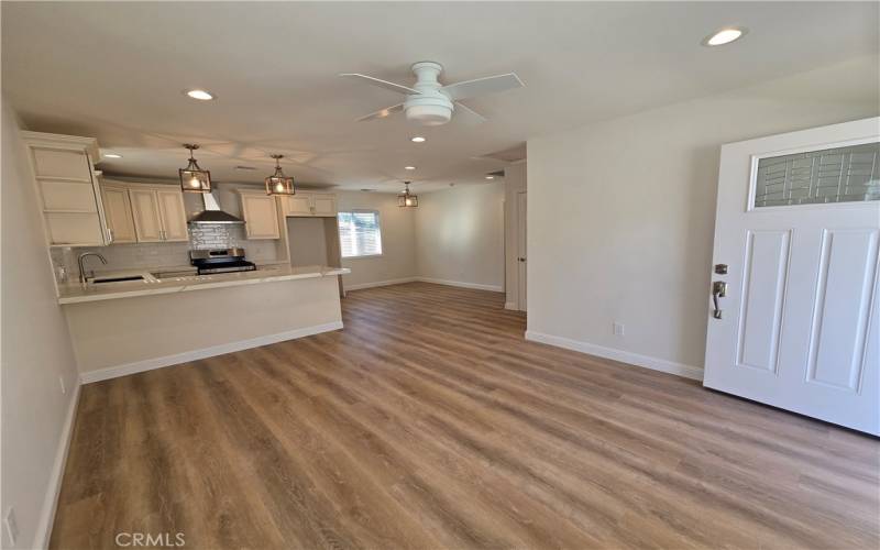 Bright, airy, and spacious living room, that opens into the spacious and elegant kitchen.