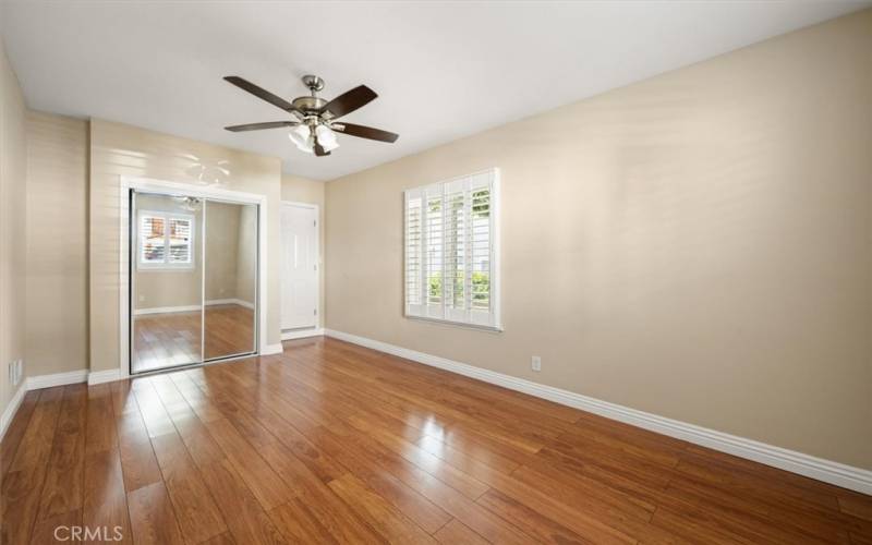 Second Bedroom with Mirrored Closet Doors and Designer Fan