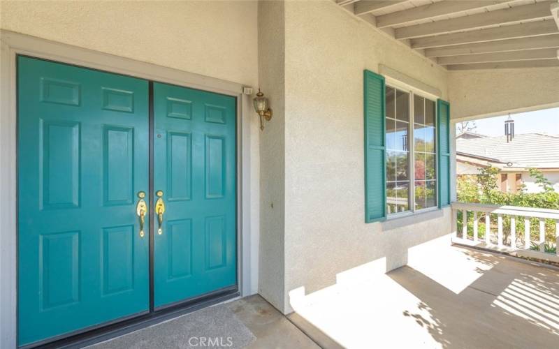 Elegant double entry doors with a cozy porch, providing a warm and inviting entrance.











