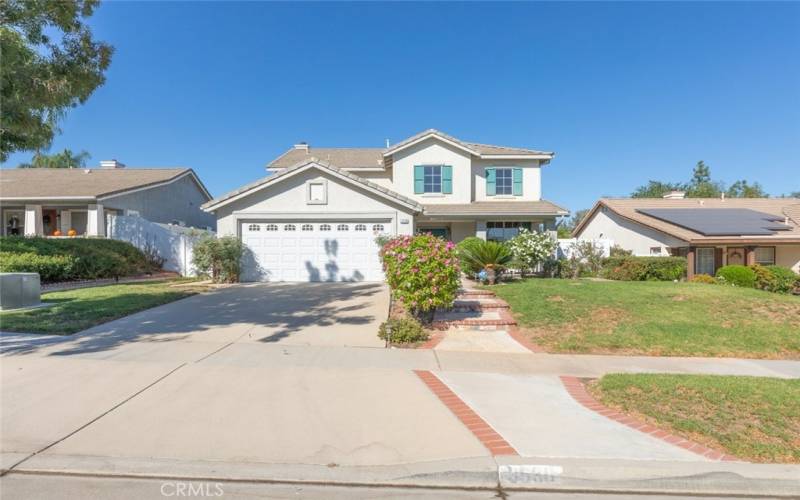 Charming curb appeal with colorful landscaping and a spacious driveway offering plenty of parking.