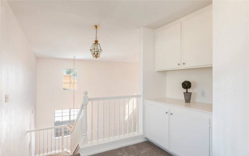 Upstairs hallway with extra cabinet space, providing convenient storage solutions.